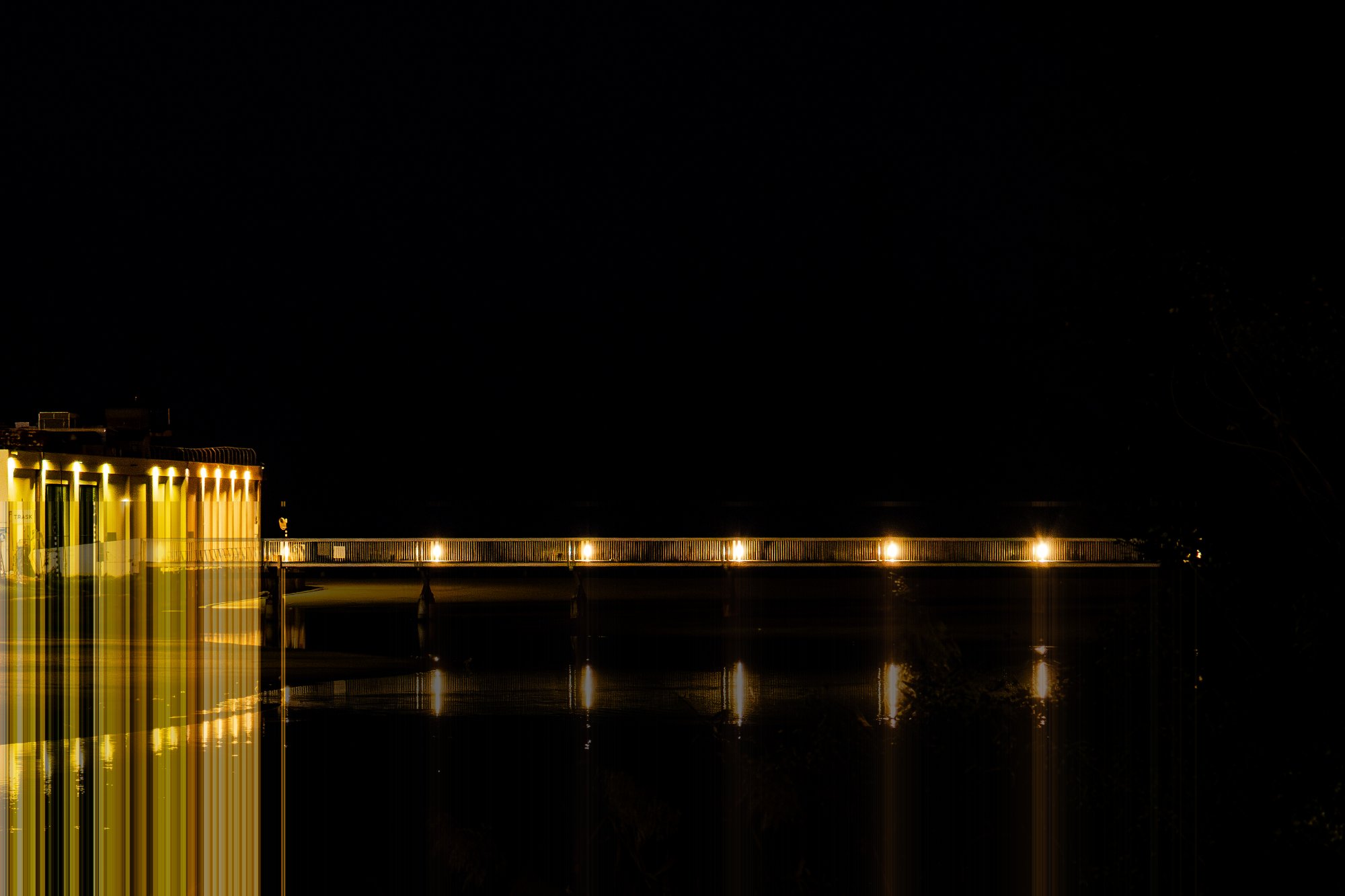 Night bridge with vertical light streaks